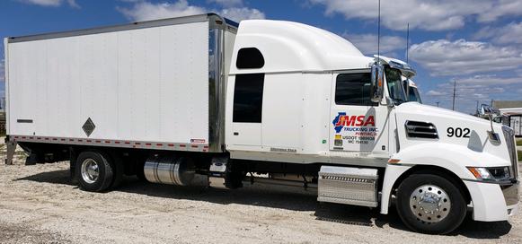 White JMSA straight truck on a gravel lot